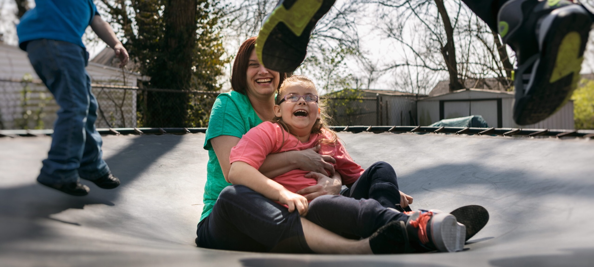 Girl and her foster carer on trampoline